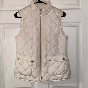 White puffer vest with gold details